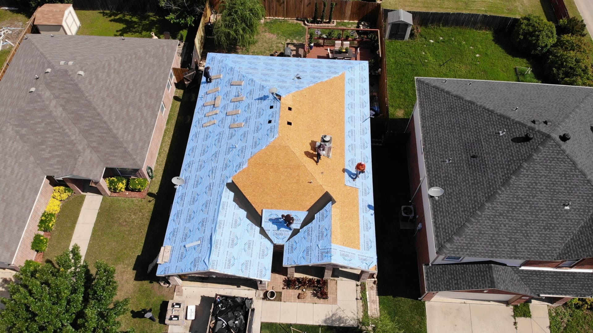 Tear-off in progress, old covering stripped back to the deck